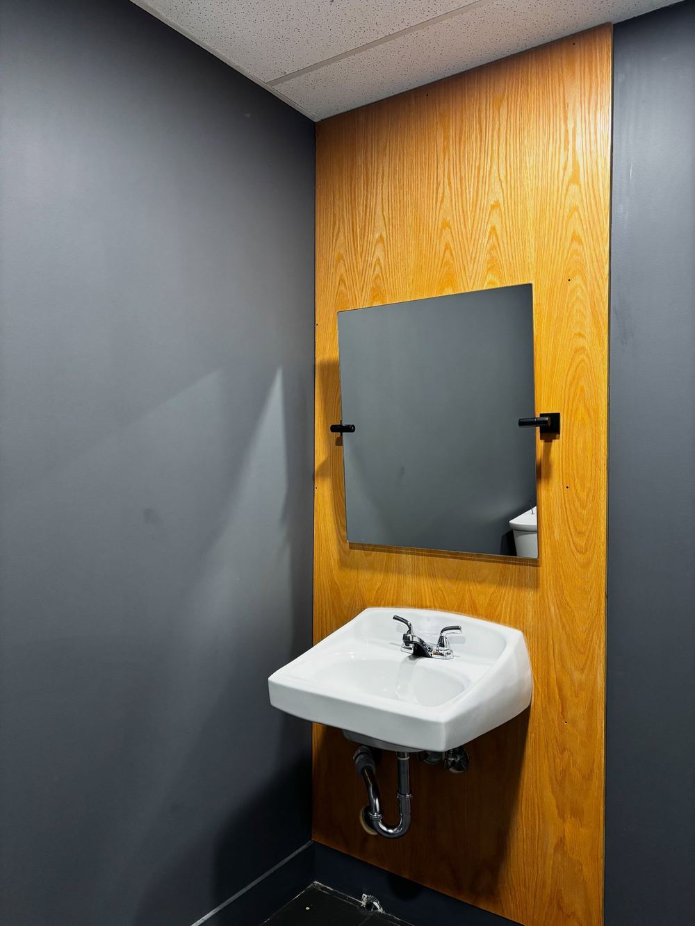 Restored accessible washroom in a Langley restaurant with new sink and mirror