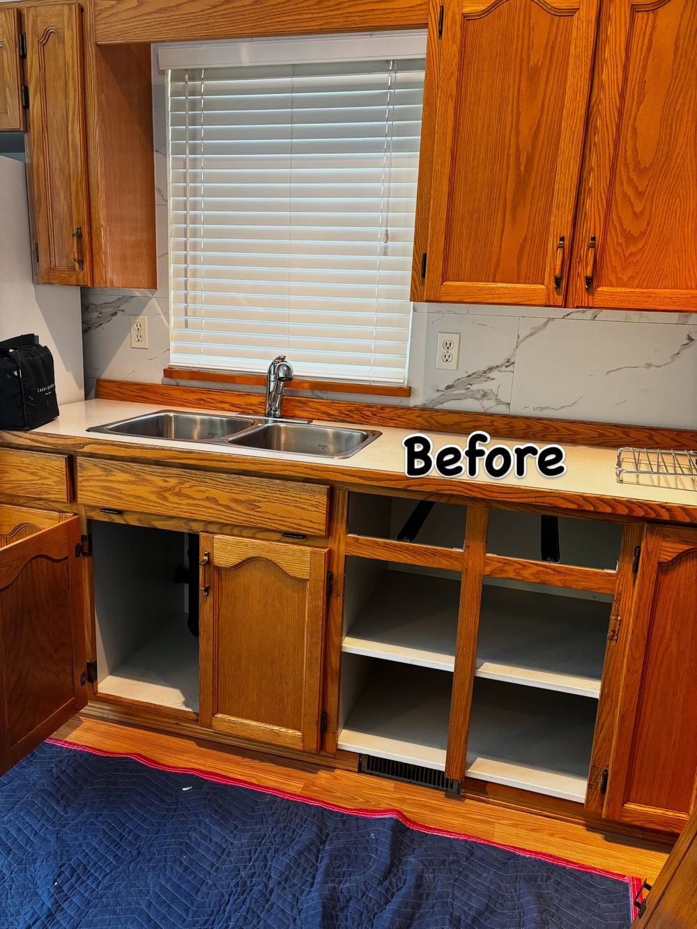 Kitchen before: a cabinet where the dishwasher would go